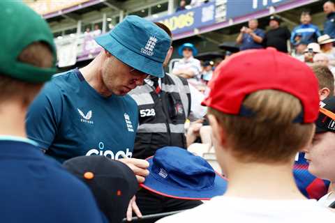 Andrew Flintoff smiles and signs autographs for fans as he coaches England cricket team after..