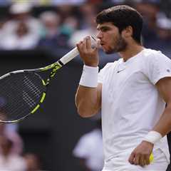 Why do tennis players like Carlos Alcaraz blow on their fingers and hands?