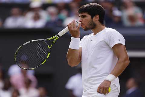 Why do tennis players like Carlos Alcaraz blow on their fingers and hands?